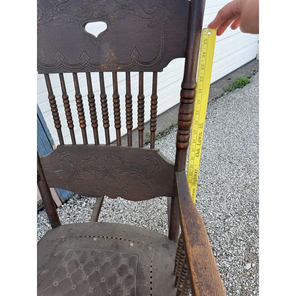 Antique Spindle Rocking Chair With Carvings and Cutout accent
